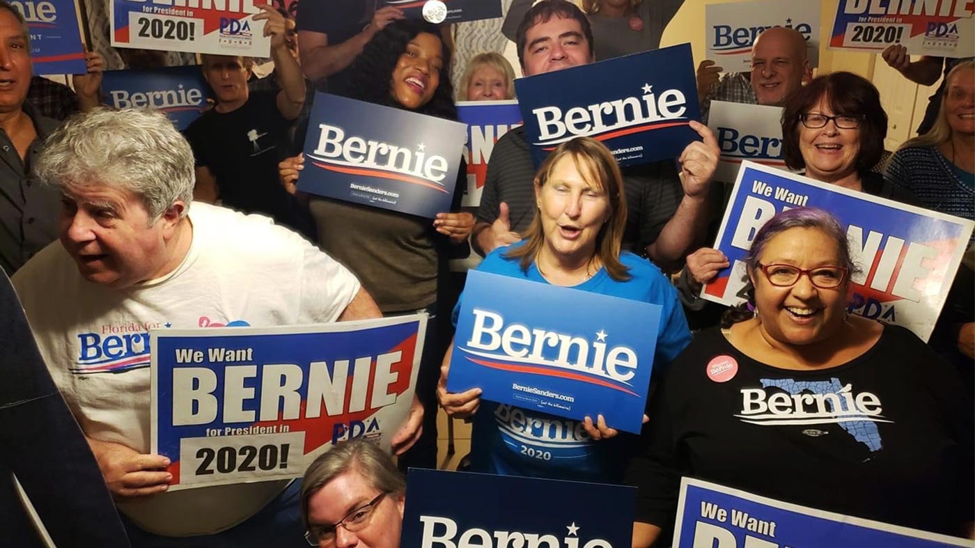 Sher Delva poses for a photo with several other Bernie Sanders supporters during a debate watch party in January 2020.